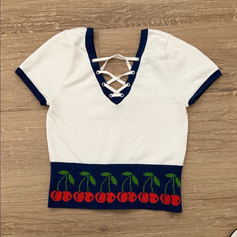 Urban outfitters graphic lace up short sleeve sweater size S/m